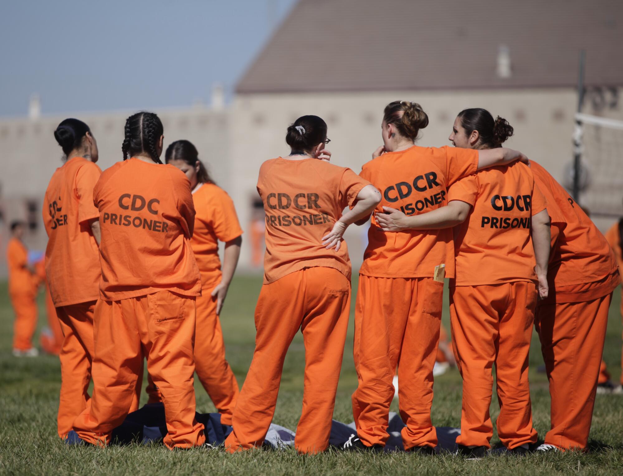 Inmates stand together in a yard at the Central California Women's Facility in Chowchilla