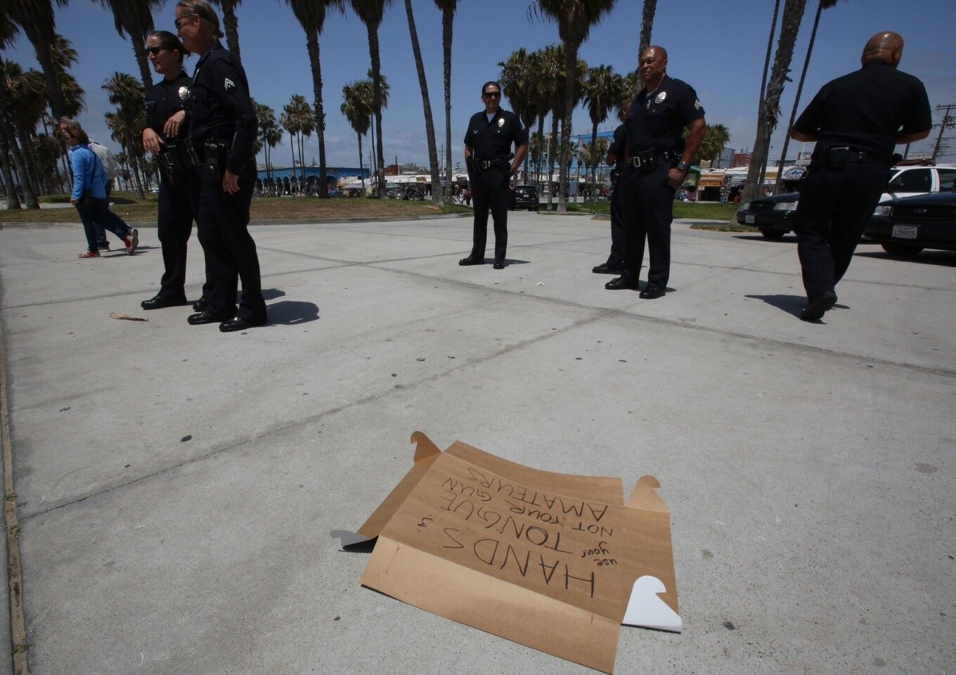 LAPD officers keep an eye on protesters near the site of a fatal LAPD officer-involved shooting in Venice.