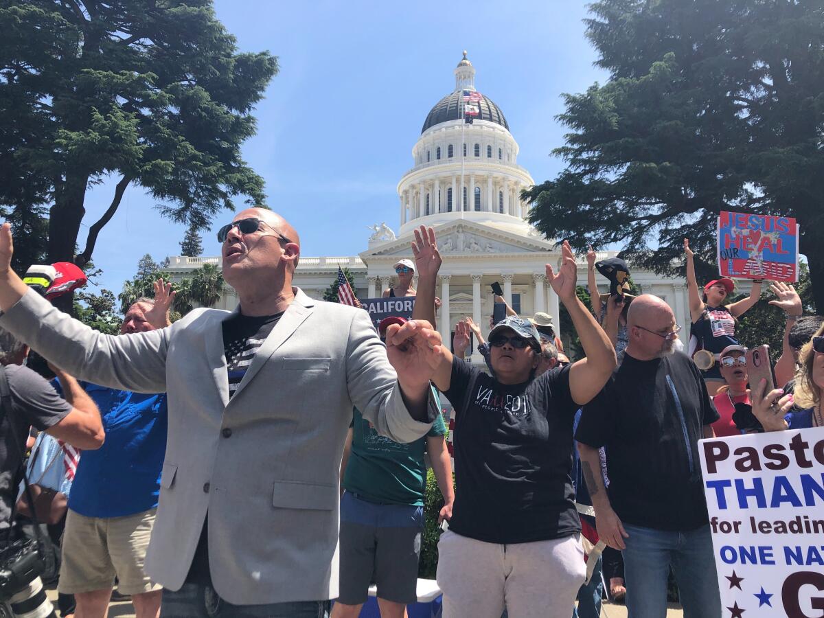 Pastor Tim Thompson of Riverside leads a protest at the state Capitol in Sacramento on May 7, 2020, against Gov. Gavin Newsom's restrictions to stem the spread of the coronavirus.