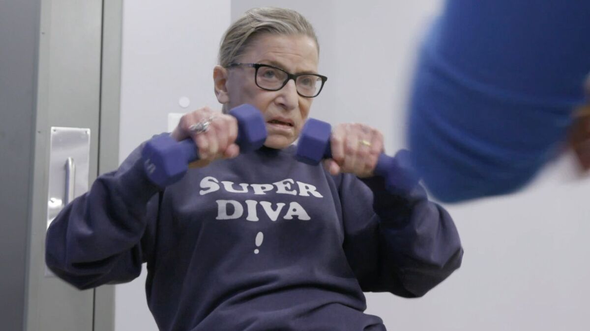  Justice Ruth Bader Ginsburg lifts weights wearing a "Super Diva" sweatshirt.