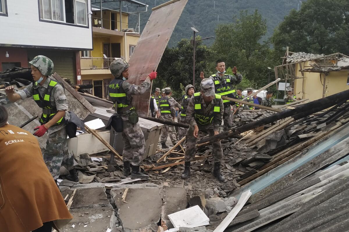 Soldiers clearing debris in search for earthquake survivors