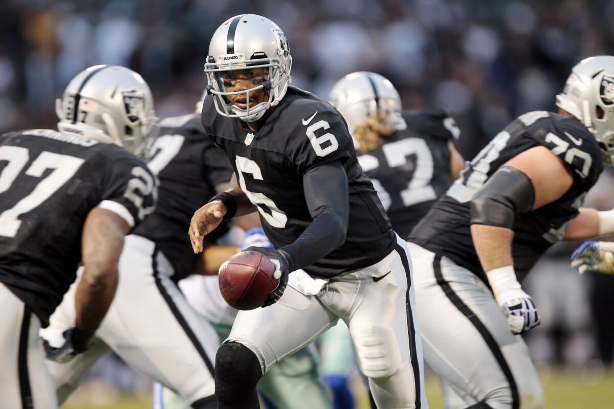 Oakland Raiders quarterback Terrelle Pryor hands off the ball during a preseason game against Dallas Cowboys on Friday. The former Ohio State standout says he's ready to make on-field contributions for the Raiders this season.