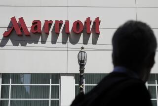 FILE - A person walks past the San Francisco Marriott Union Square hotel on July 11, 2019, in San Francisco. Multinational companies including Amazon, Marriott and Hilton pledged Monday June 19, 2023 to hire more than 13,000 refugees, including Ukrainian women who have fled the war with Russia, over the next three years in Europe. (AP Photo/Jeff Chiu, File)