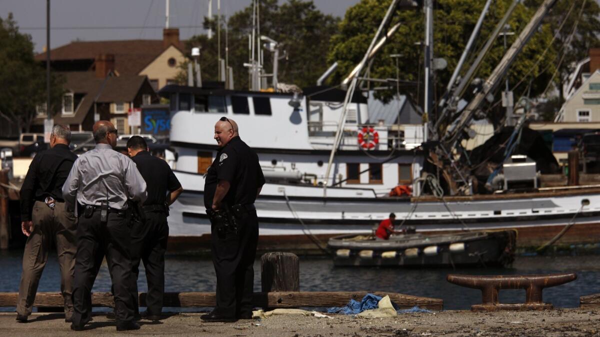 LAPD Harbor Division detectives and police officers investigate the scene of a crash in 2015 that killed two children after their family car plunged into the San Pedro harbor.