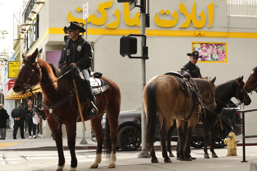 LOS ANGELES-CA-FEBRUARY 17, 2023: LAPD on horseback along Pico Boulevard after the recent shootings of two Jewish men in the Pico-Robertson area of Los Angeles on Thursday, February 17, 2023. (Christina House / Los Angeles Times)