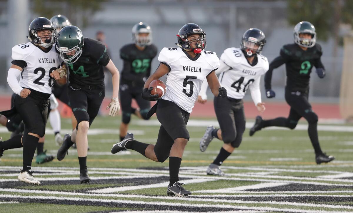 Katella's Donnovan Arrington runs into open space for the end zone as he scores a touchdown on the game's opening kickoff.