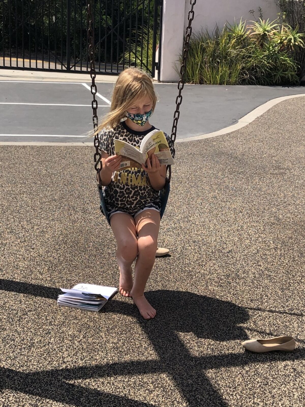 A Rowe student reads a book outdoors at school.