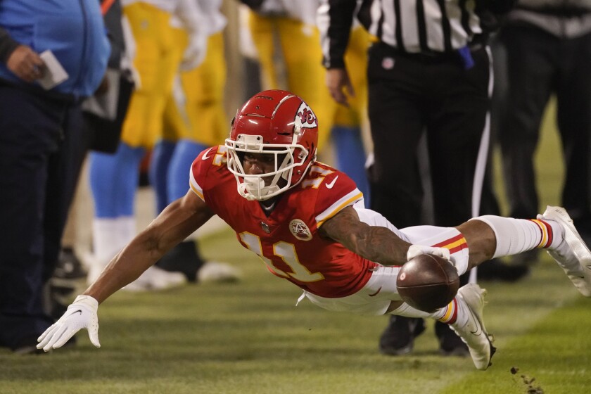 Kansas City Chiefs wide receiver Demarcus Robinson dives for extra yardage during the second half of an NFL football game against the Los Angeles Chargers, Sunday, Jan. 3, 2021, in Kansas City. (AP Photo/Charlie Riedel)