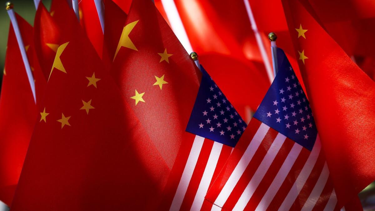 Chinese and U.S. flags are displayed in Beijing.