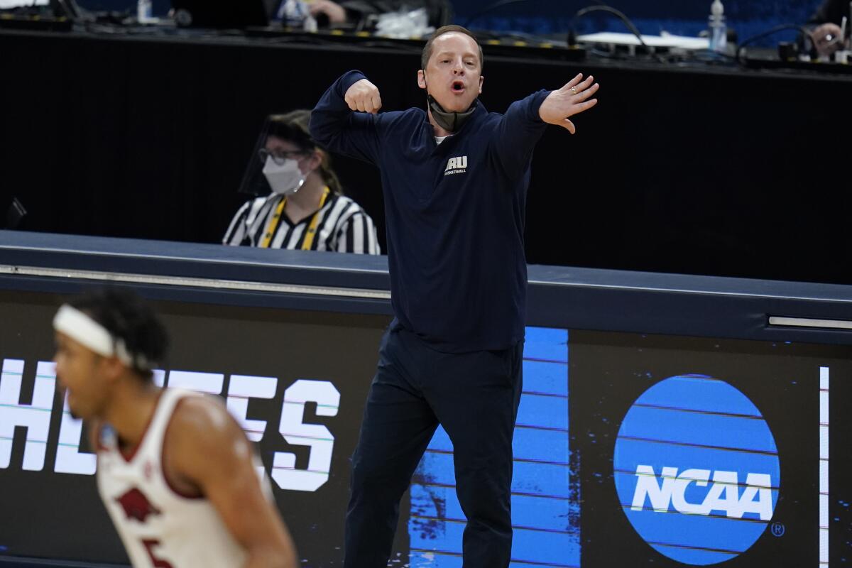 Oral Roberts head coach Paul Mills directs his team during the second half of a Sweet 16 game against Arkansas in the NCAA men's college basketball tournament at Bankers Life Fieldhouse, Saturday, March 27, 2021, in Indianapolis. (AP Photo/Jeff Roberson)