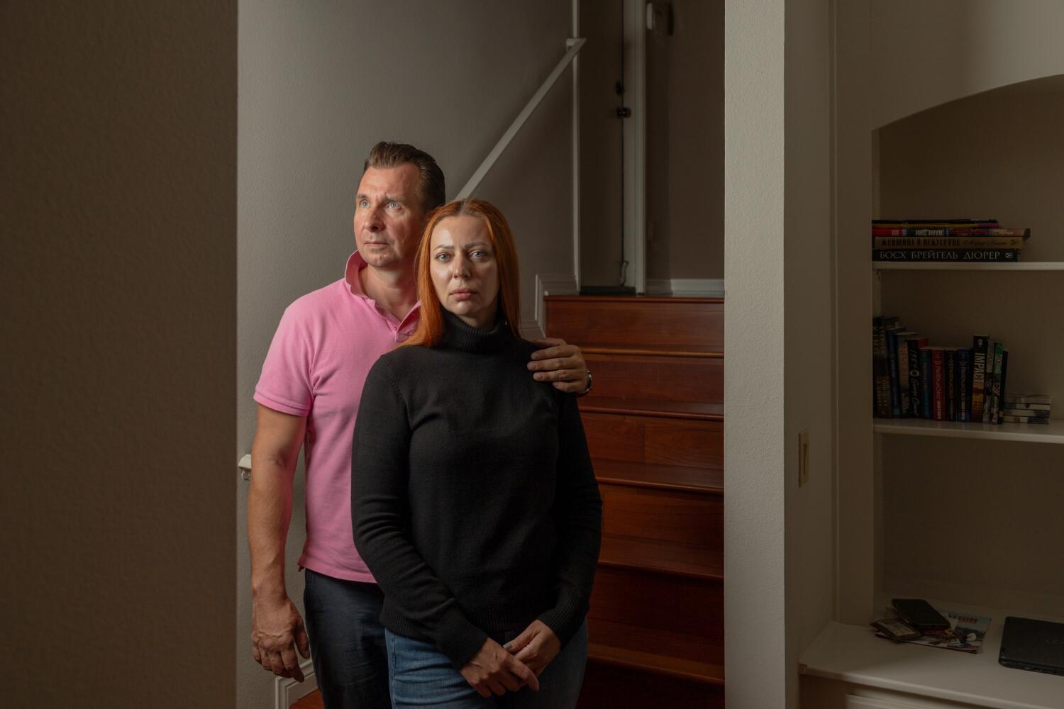 Westlake Village, CA - October 30: Anton Perevalov and his wife Tatiana Zaiko stand for a portrait in their home on Thursday, Oct. 30, 2025 in Westlake Village, CA. The couple was arrested by immigration agents in August while Perevalov was walking their dog, and spent a month detained in separate facilities although they both have asylum and documentation to work legally in the United States. (Juliana Yamada / Los Angeles Times)
