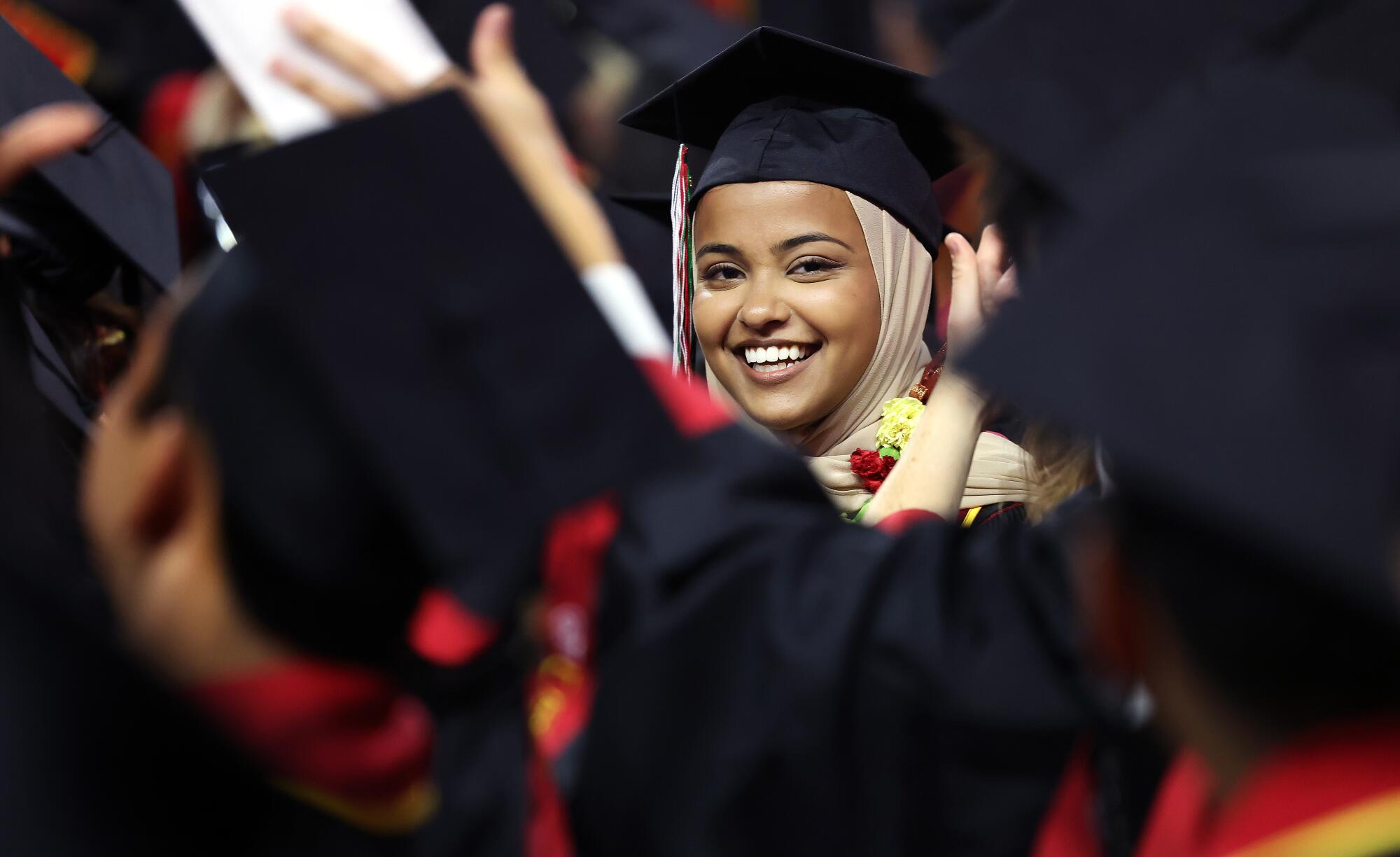 USC valedictorian Asna Tabassum is framed by other students in soft focus