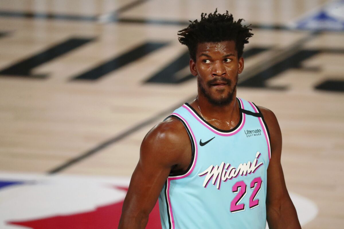Miami Heat forward Jimmy Butler waits between plays during the first half of the team's NBA basketball game against the Indiana Pacers on Monday, Aug. 10, 2020, in Lake Buena Vista, Fla. (Kim Klement/Pool Photo via AP)