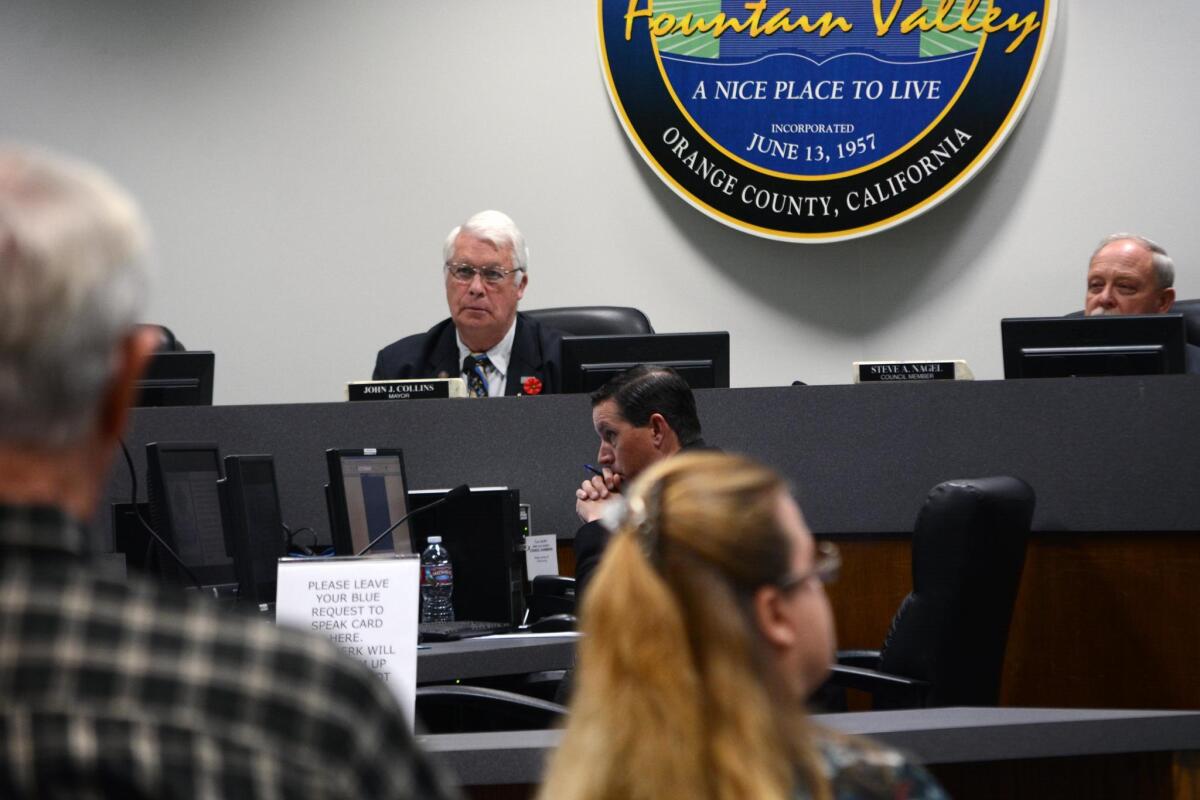 Fountain Valley Mayor John Collins listens during a City Council meeting Tuesday. Collins has served on the council for 26 years.