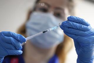 A nurse prepares a shot of the Pfizer COVID-19 vaccine in London.