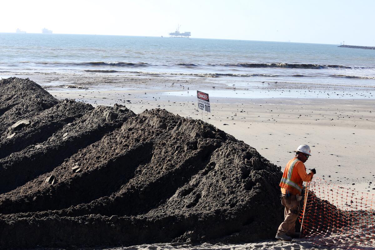 A sand berm is formed along the shore for the Surfside-Sunset Beach sand replenishment project.