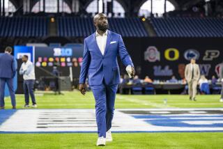 UCLA head coach DeShaun Foster walks toward a stage where he will talk with reporters during an NCAA college football news conference at the Big Ten Conference media days at Lucas Oil Stadium, Wednesday, July 24, 2024, in Indianapolis. (AP Photo/Doug McSchooler)