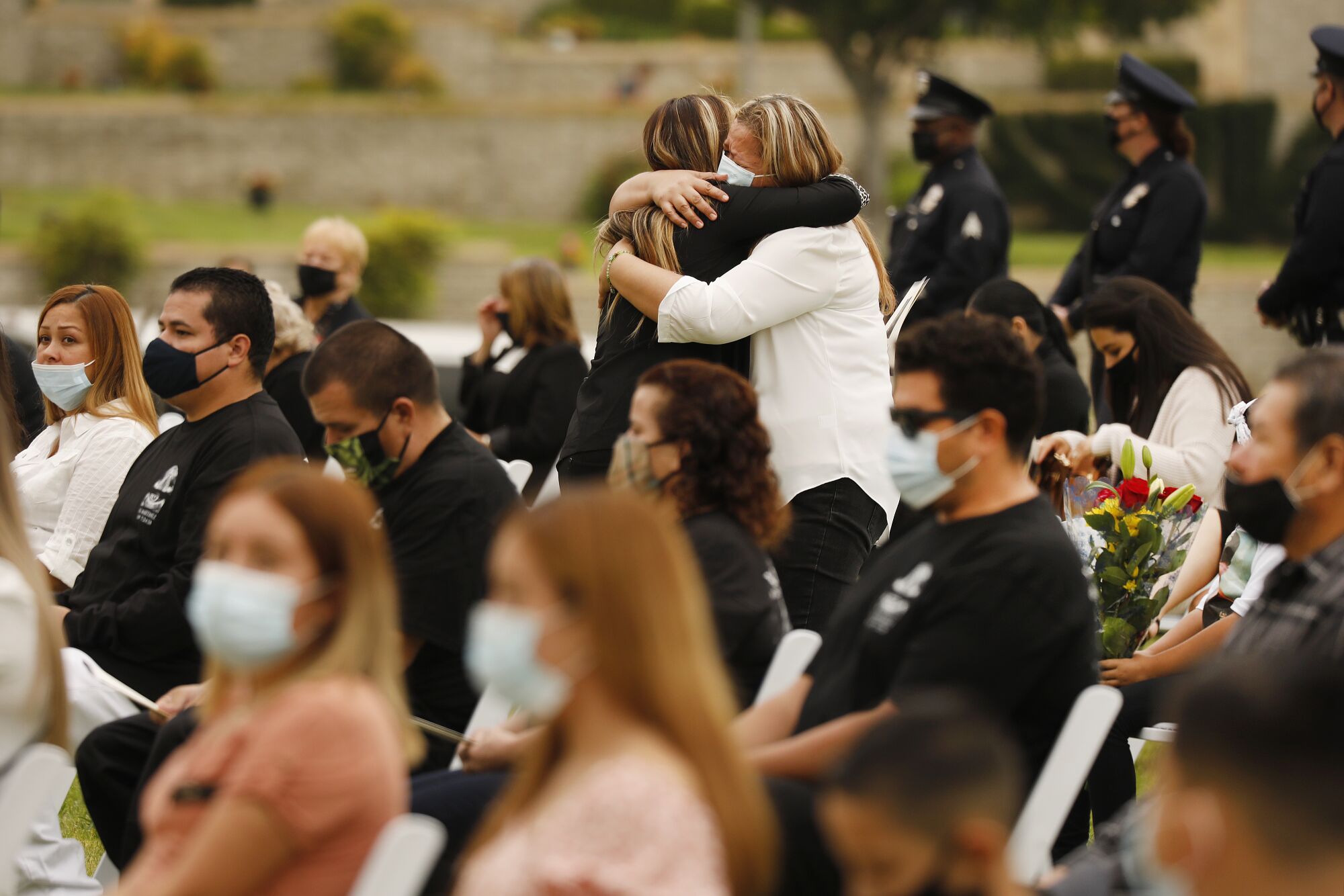 Mourners embrace at the memorial service. 