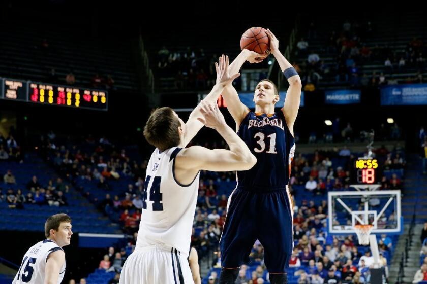 Mike Muscala of the Bucknell Bison shoots against Andrew Smith of the Butler Bulldogs in the first half.