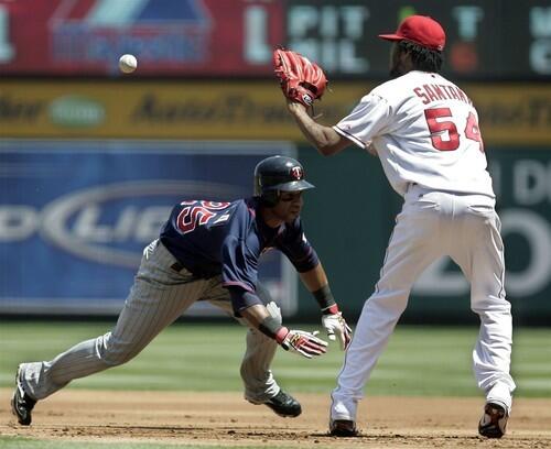 Minnesota's Alexi Casilla gets caught off base and is tagged out by Angels pitcher Ervin Santana in the first inning.