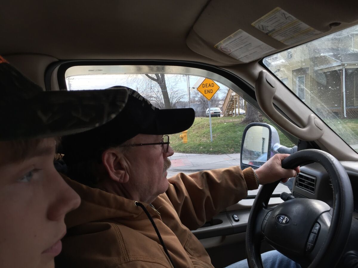 Bruce Goacher, right, drives his tow truck in Davenport, Iowa, with his son, Alan. He is a strong supporter of Donald Trump.