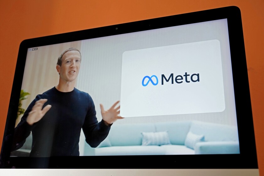 Seen on a video screen in Sausalito, Calif., Facebook CEO Mark Zuckerberg announces his company's new name, Meta.