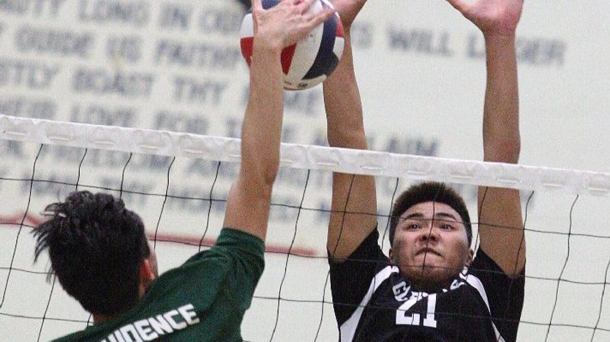 Glendale's Pat Sungkamee reaches for a block as Providence's Kenneth DelaRosa hits an attack.