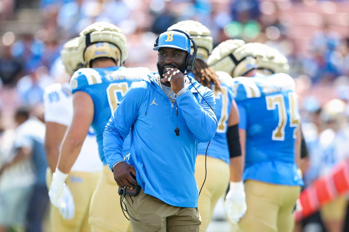 UCLA coach DeShaun Foster stands on the field at the Rose Bowl during the UCLA football spring showcase.