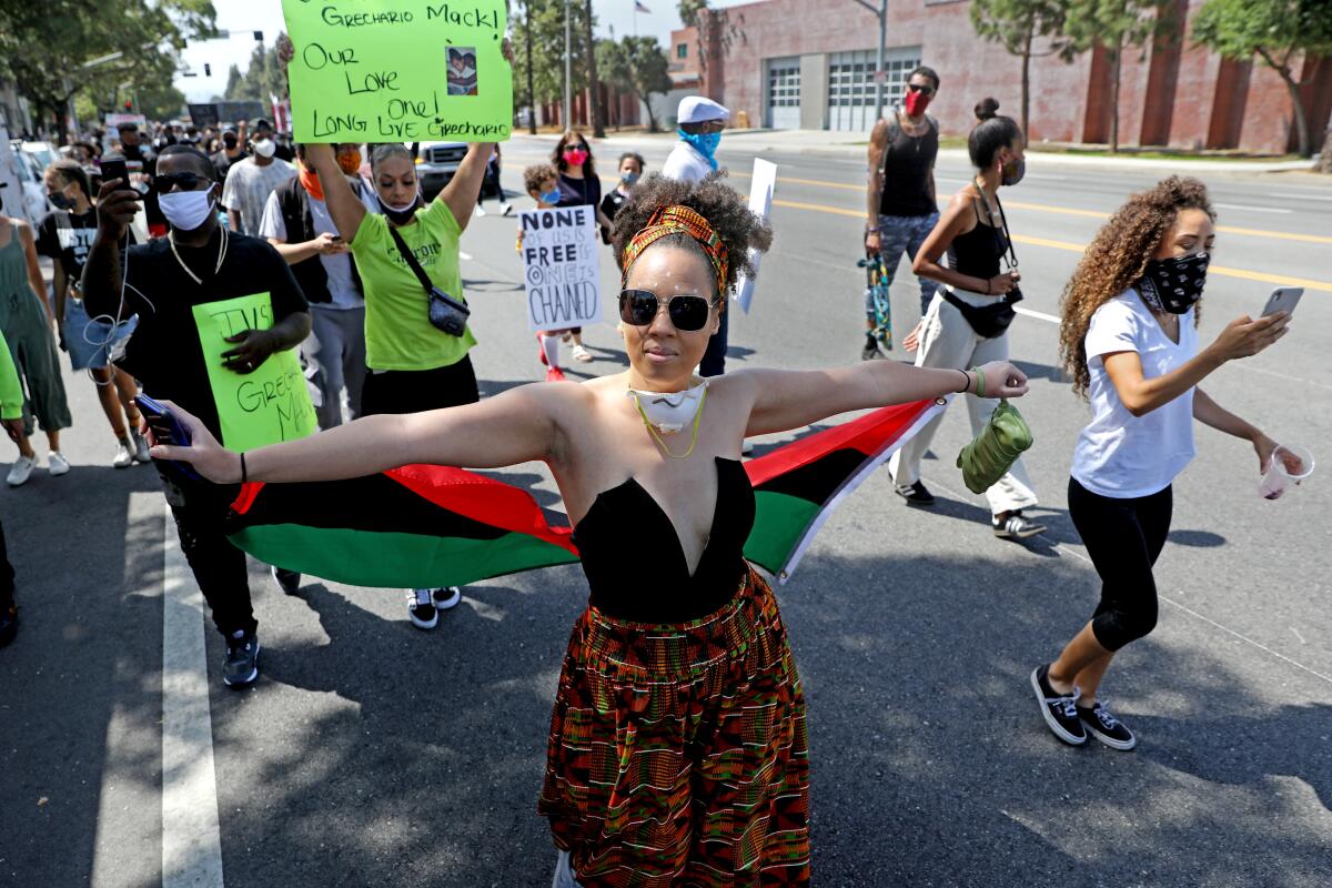 People march along Martin Luther King Boulevard in Los Angeles on June 19, 2020 