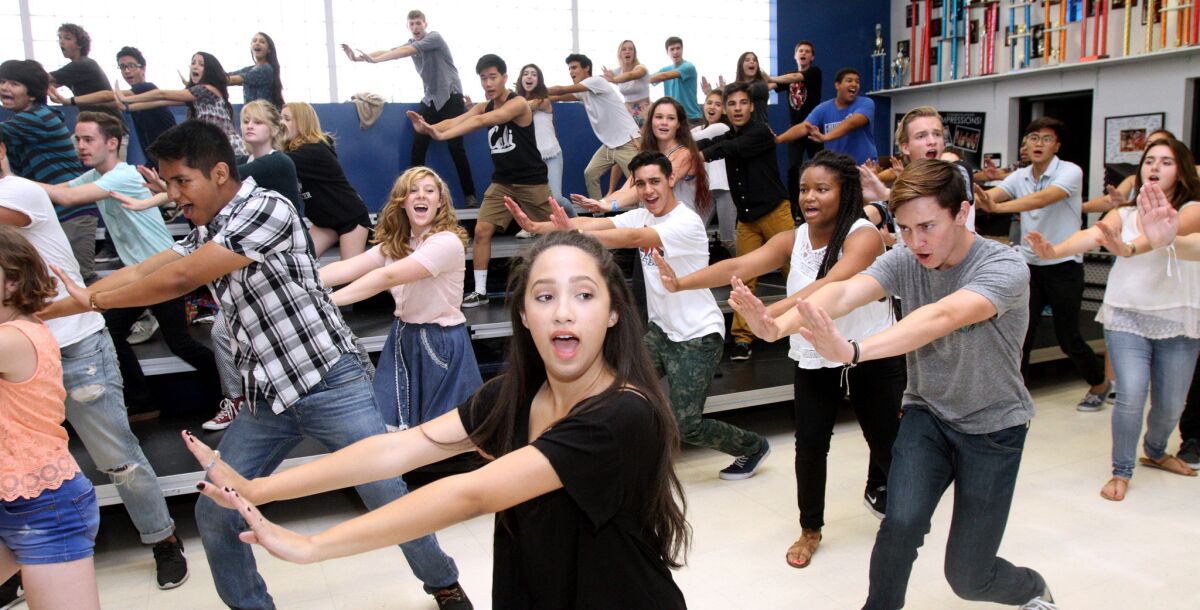 Noa Drake, center, sings and dances along with the rest of the members of Burbank High School's show choir during a practice at the school in 2015.