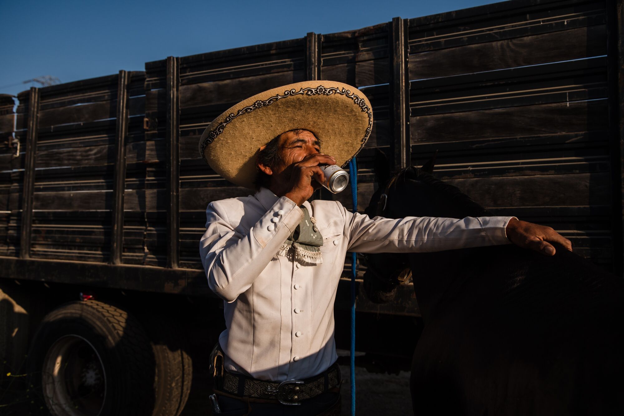 Casimiro Castillo, a member of the Charros Rancho La Laguna team drinks a beer