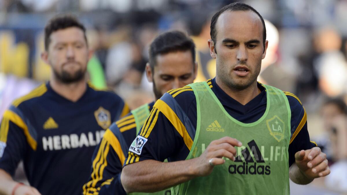 Galaxy forward Landon Donovan, right, warms up with his teammates before a match against the Seattle Sounders on Oct. 19.