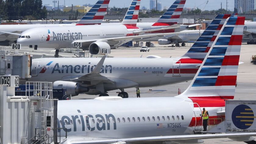 A union leader denied any slowdown and said contract talks with American Airlines were stalled over pay, healthcare benefits and job security.