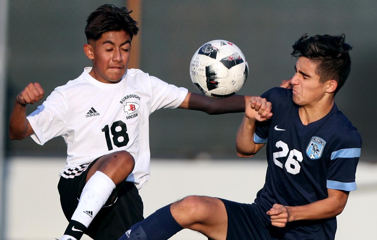 Burroughs High's Patrick Abarca, left, and Emil Barseghian of Crescenta Valley battle for the ball during Friday's Pacific League contest.
