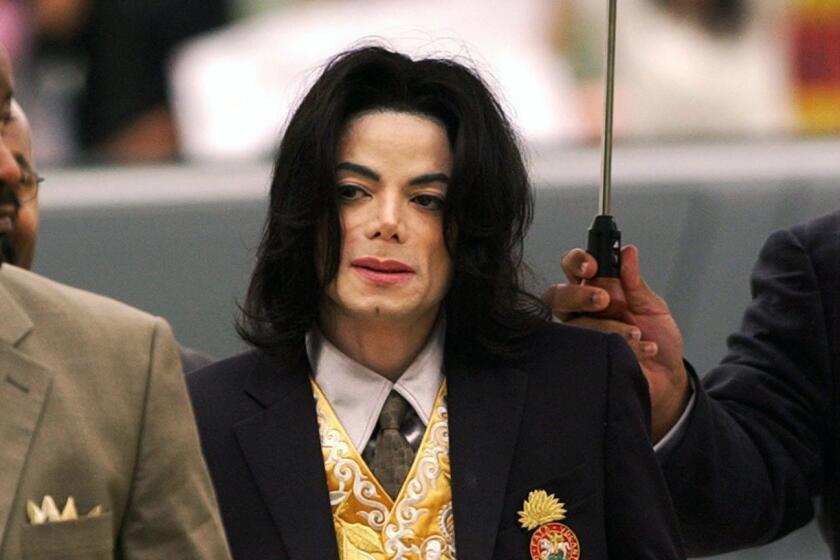 FILE - In this May 25, 2005 file photo, Michael Jackson arrives at the Santa Barbara County Courthouse for his trial in Santa Maria, Calif. A settlement has been reached in a lawsuit between Tohme Tohme, a former manager of Michael Jackson, and his estate. The settlement announced Thursday, May 23, 2019, ends one of the last remaining legal fights involving Jacksons estate and comes just short of the 10th anniversary of the pop superstars death. (Aaron Lambert/Santa Maria Times via AP, Pool)