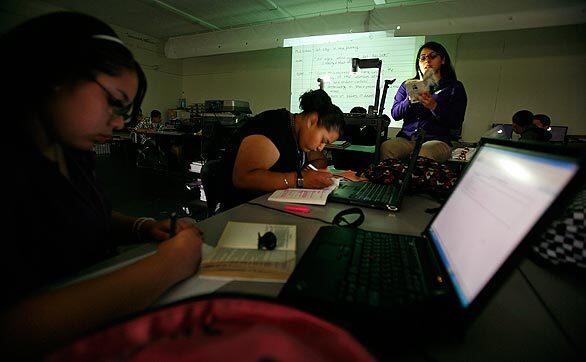 Sally Zuniga goes over a lesson at the Student Empowerment Academy, where discipline and personalized attention are credited for raising test scores on the latest Academic Performance Index.