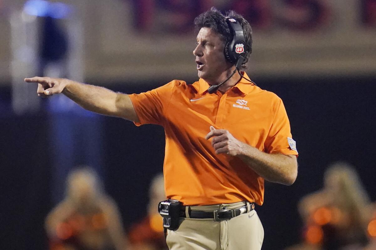 Oklahoma State coach Mike Gundy gestures during the second half of the team's NCAA college football game against Central Michigan, Thursday, Sept. 1, 2022, in Stillwater, Okla. Oklahoma State won 58-44 to give Gundy his 150th coaching victory. (AP Photo/Sue Ogrocki)