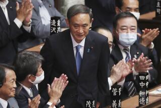 Yoshihide Suga is applauded after being elected as Japan's new prime minister on Wednesday.