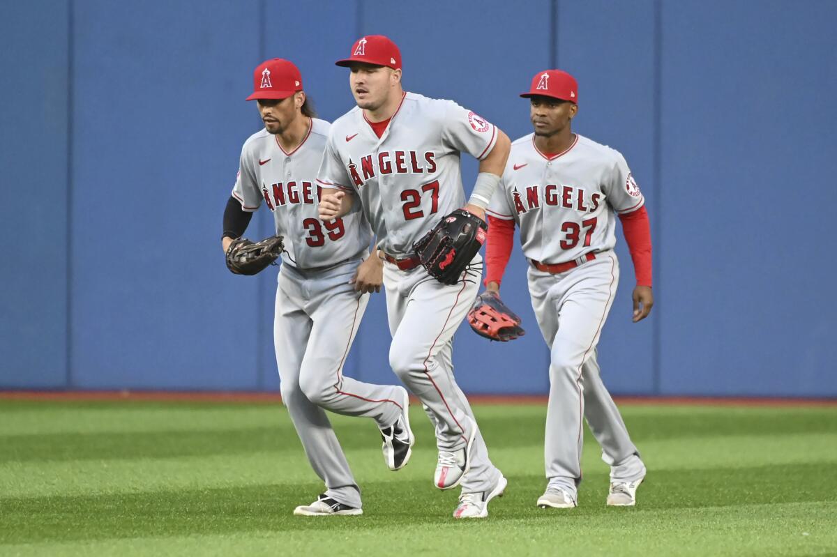 Angels outfielders Ryan Aguilar, Mike Trout and Magneuris Sierra celebrate after a win over the Toronto Blue Jays.