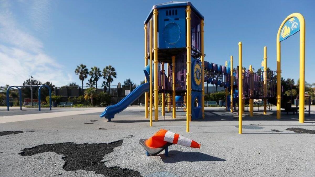 A bent cone covered the foot of a missing slide at Peter Green Park in Huntington Beach in November. A new slide has since been installed.
