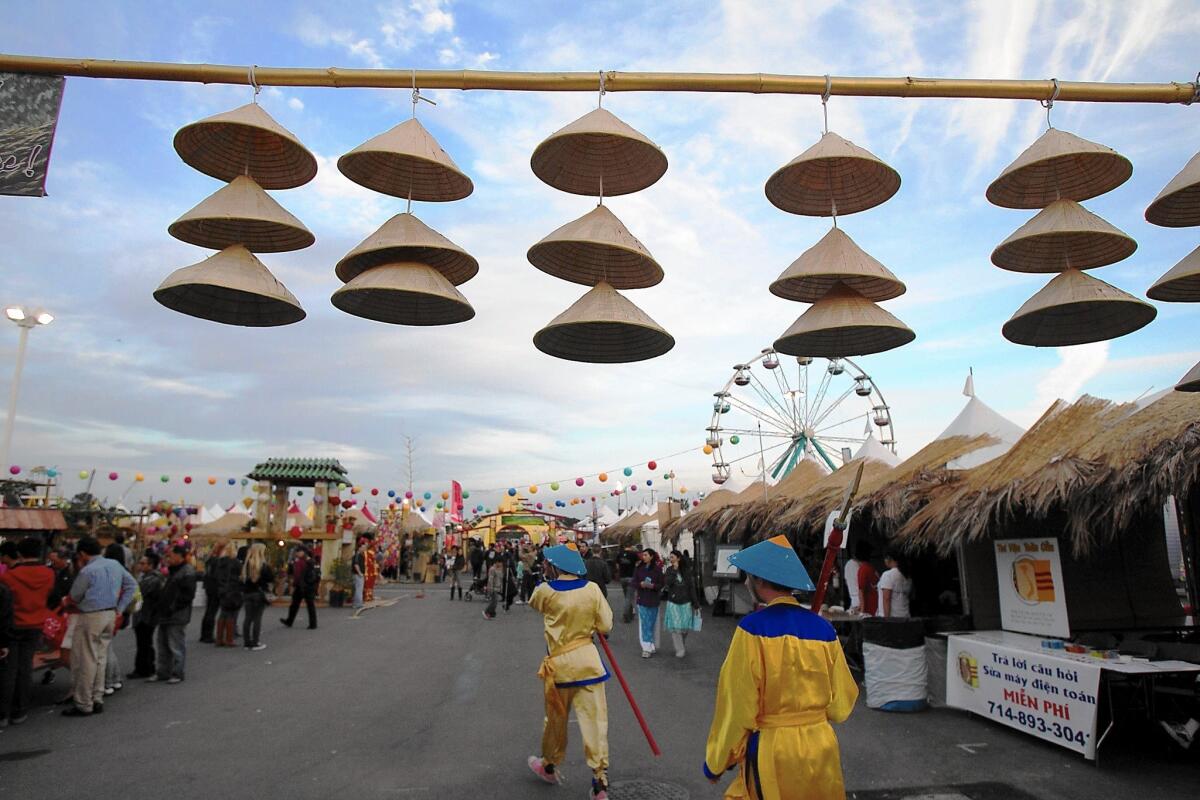 Traditional Vietnamese hats hang above a walkway at the 2015 UVSA Tet Festival at the OC Fair & Event Center in Costa Mesa. This year's three-day festival begins Friday.