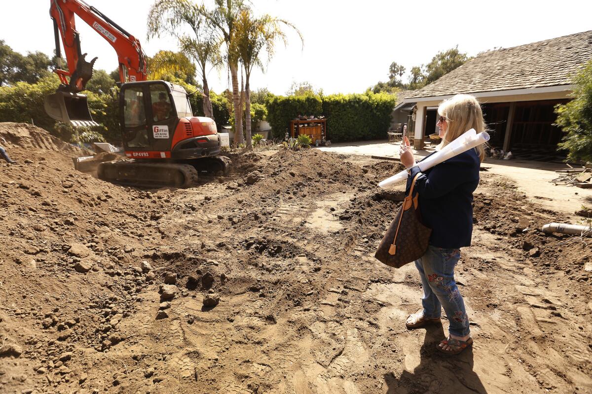 Kim Cantin takes photos behind a home in Montecito. She divides her life into chapters — “before” and “after” the mudslides