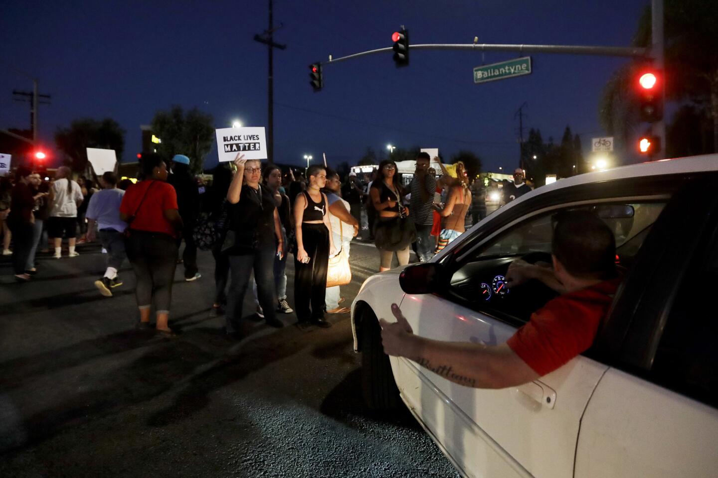 A driver yells at demonstrators blocking a street in El Cajon.