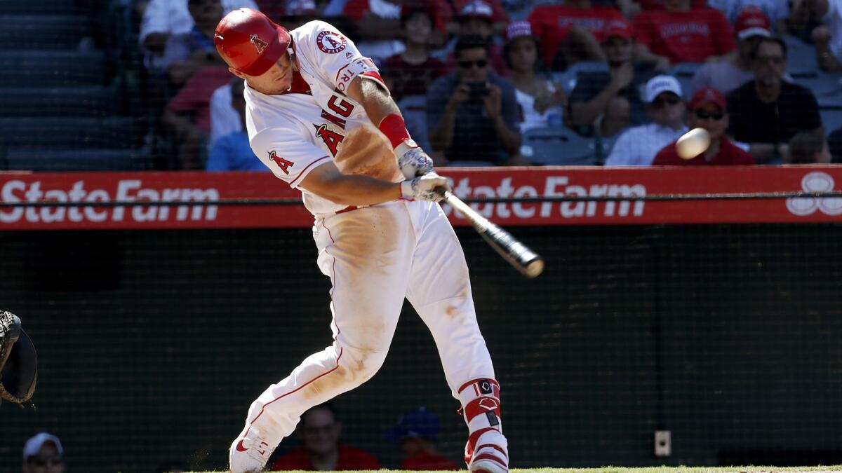 Angels center fielder Mike Trout hits a two-run homer against the Houston Astros in the seventh inning on Sunday at Angel Stadium.