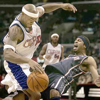 BACK-UP PLAN: Clipper forward Corey Maggette collides with Net guard Rodney Buford in the first half at Staples Center.