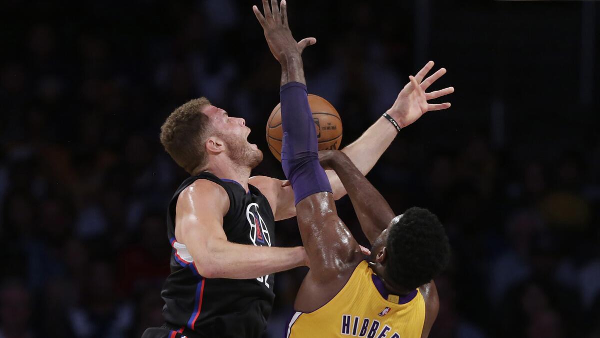 Clippers forward Blake Griffin is fouled by Lakers center Roy Hibbert during play in the first half Wednesday night.