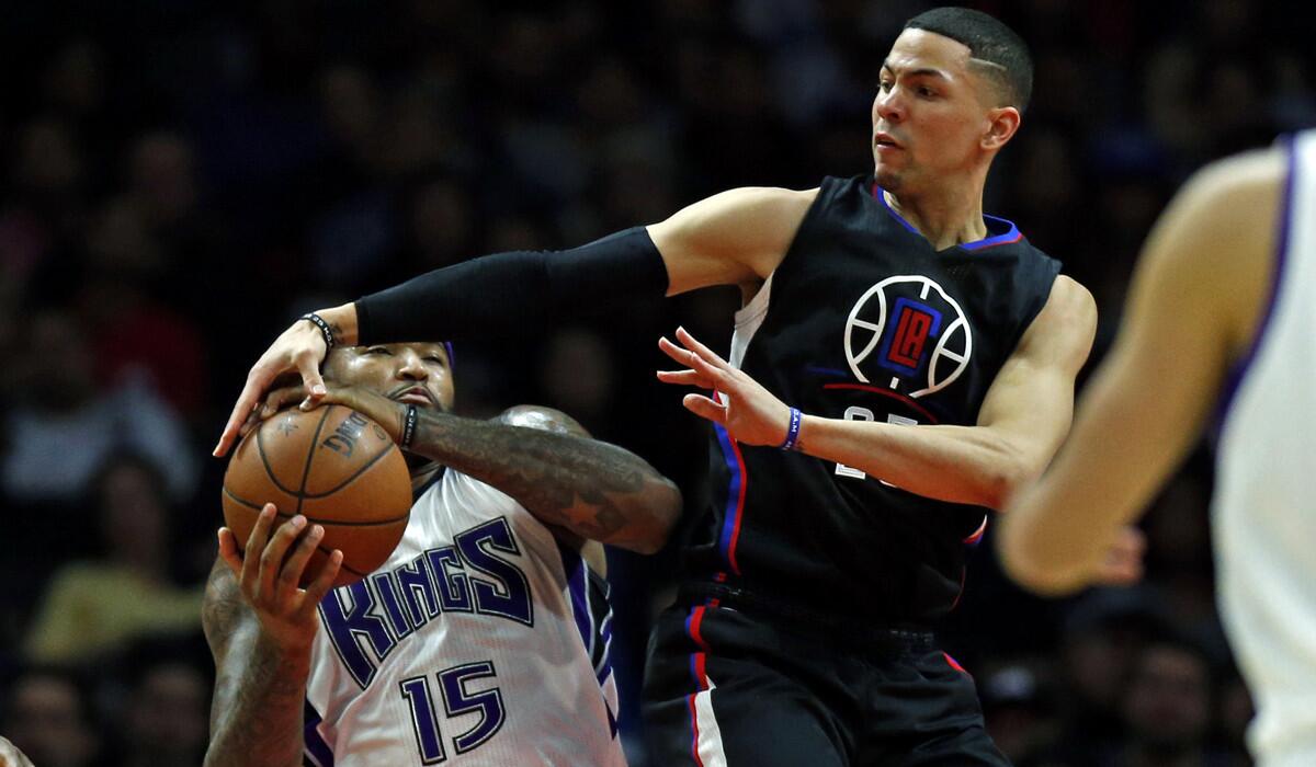 Los Angeles Clippers guard Austin Rivers, right, tries to force a jump ball against Sacramento Kings center DeMarcus Cousins in the first half at Staples Center on Saturday.