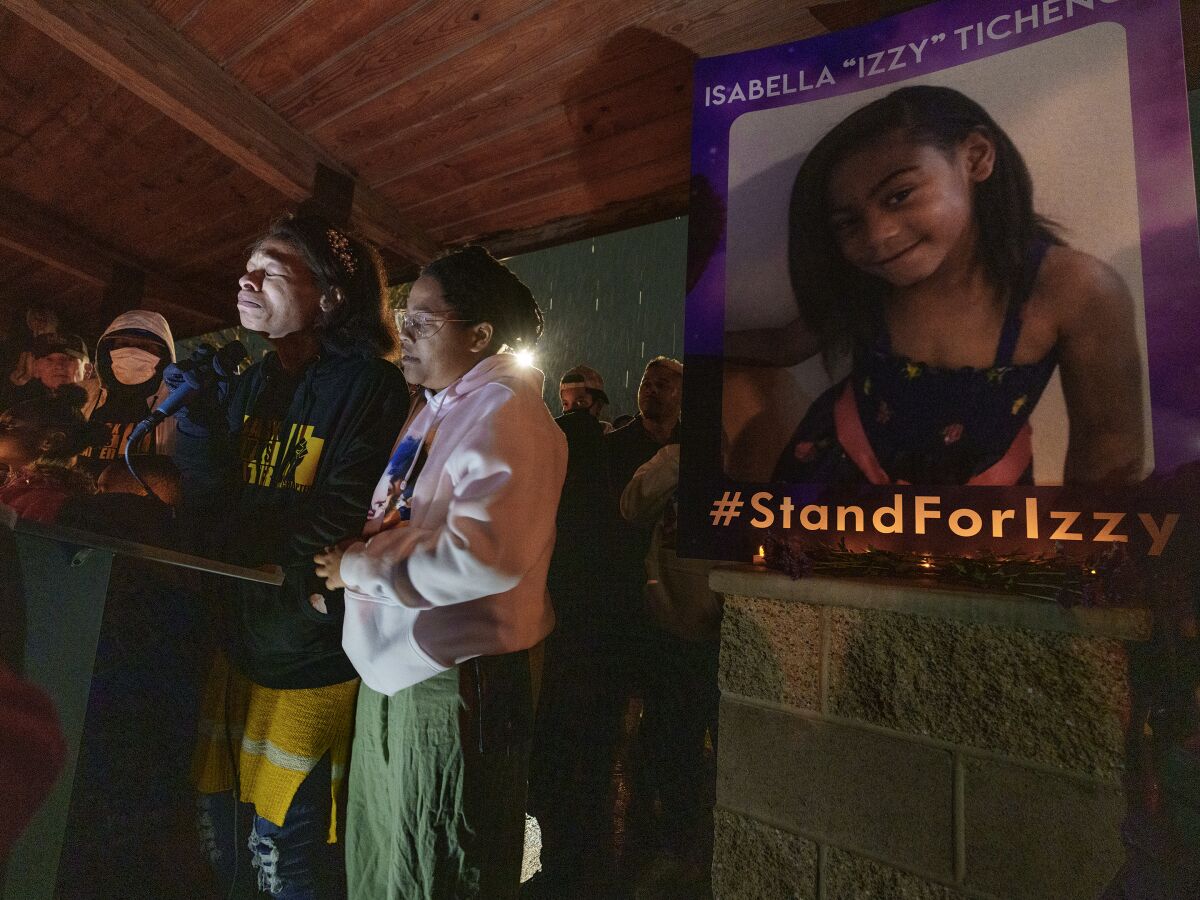 Brittany Tichenor- Cox, center, joined by her sister Jasmine Rhodes, right, speaks about her daughter Izzy Tichenor, as hundreds joined the Tichenor family in mourning the death of 10-year-old Isabella "Izzy" Tichenor during a vigil at Foxboro Hollow Park in North Salt Lake, Utah, on Tuesday, Nov. 9, 2021. Tichenor took her own life on Nov. 6th in connection to being repeatedly bullied at her Davis County school for being Black and autistic, according to her mother Brittany Tichenor. (Leah Hogsten/The Salt Lake Tribune via AP)