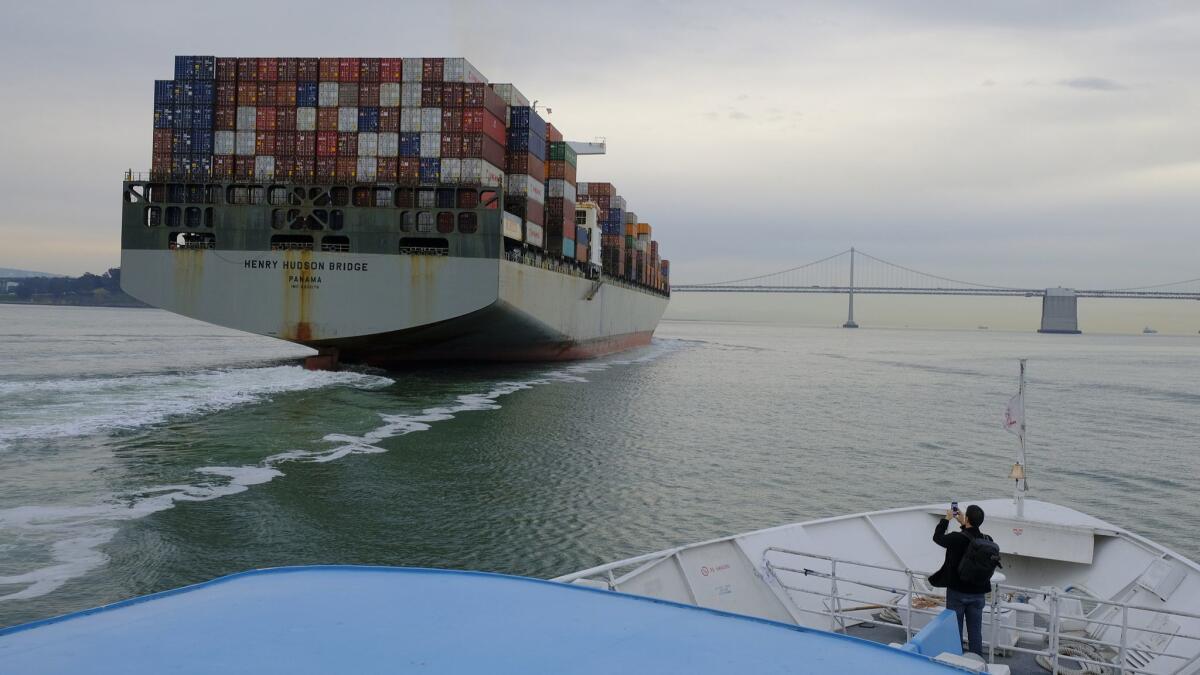A container ship heads toward the San Francisco-Oakland Bay Bridge in March.