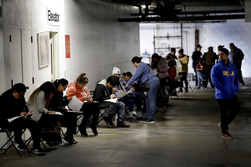 CALIFORNIA: March 13, 2020, unionized hospitality workers wait in line in a basement garage to apply for unemployment benefits at the Hospitality Training Academy in Los Angeles. More than 6.6 million Americans applied for unemployment benefits last week, far exceeding a record high set just last week, a sign that layoffs are accelerating in the midst of the coronavirus.